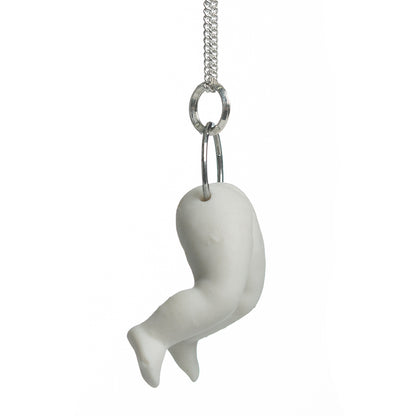 Hollow white porcelain doll's legs pendant produced by Martha Todd, one of the exhibiting artists of The Uncanny: A Centenary.