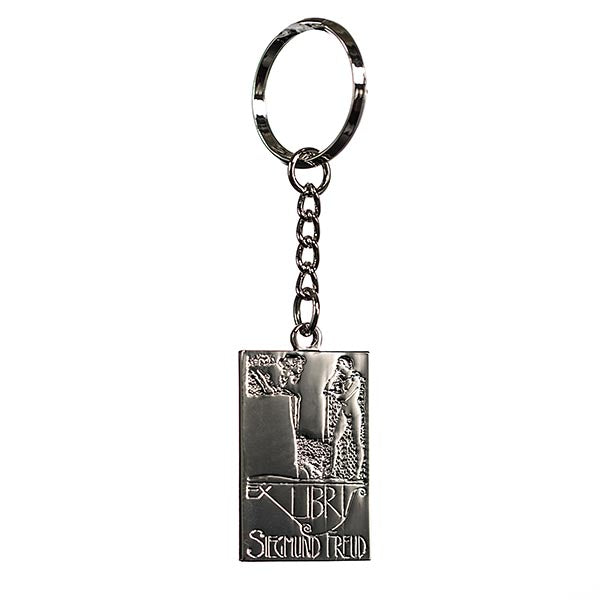 A silver keyring with a basic line drawing of Oedipus solving the riddle of the Sphinx from greek mythology. Underneath, it says "Ex Libris Sigmund Freud"